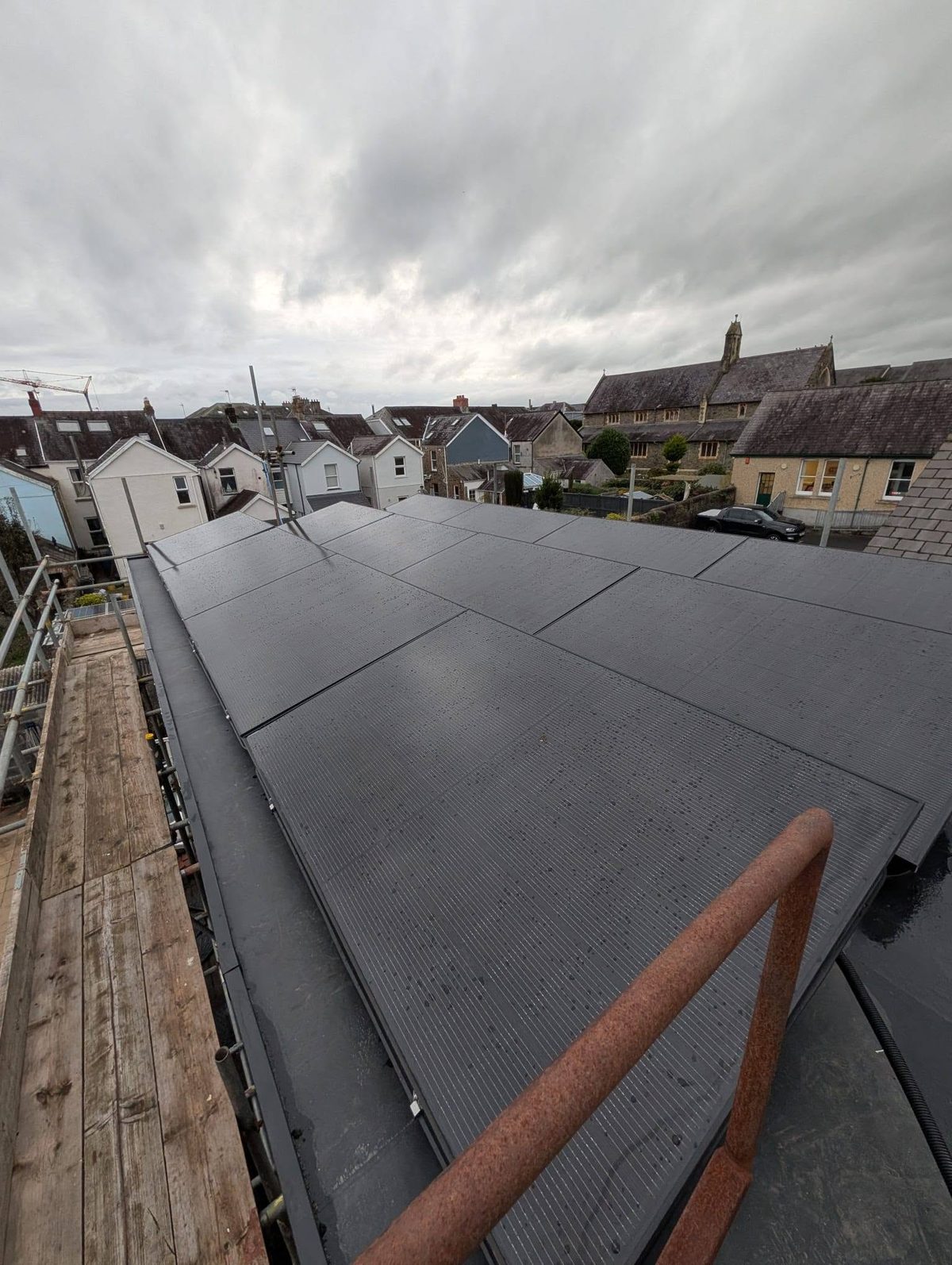 Solar PV panels installed across a flat residential roof